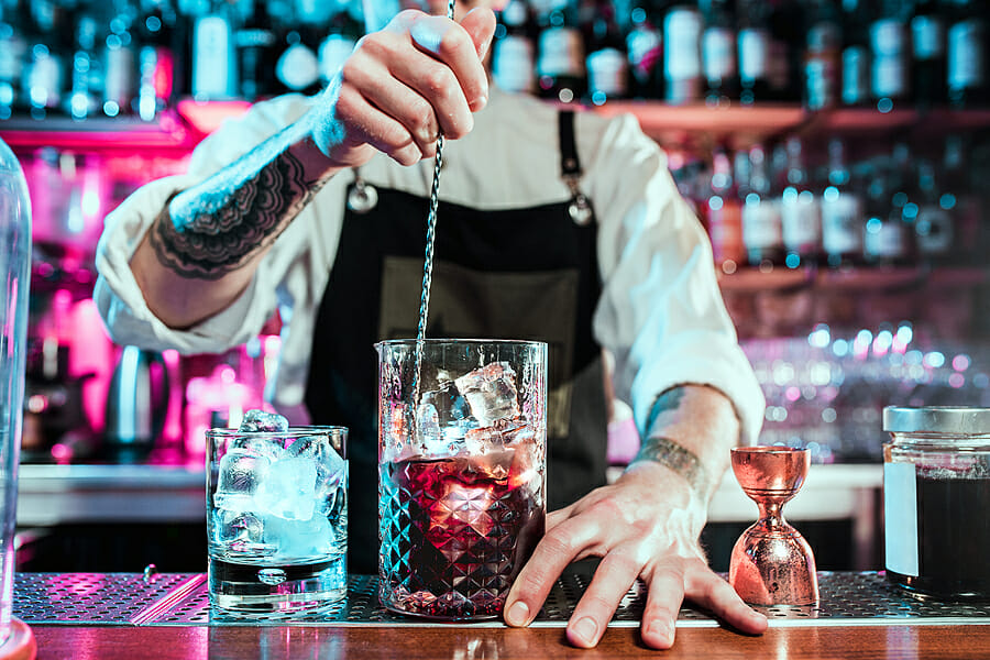 Expert Barman Is Making Cocktail At Night Club Or Bar. Glass Of
